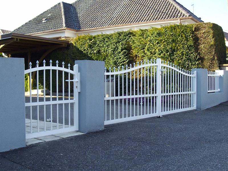 An ornate aluminium gate showing multiple decorative finials, swan neck design and classic heritage detailing.
